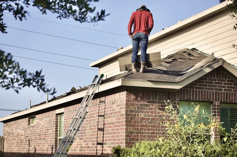 Professional roofer working on a residential roof in Stover